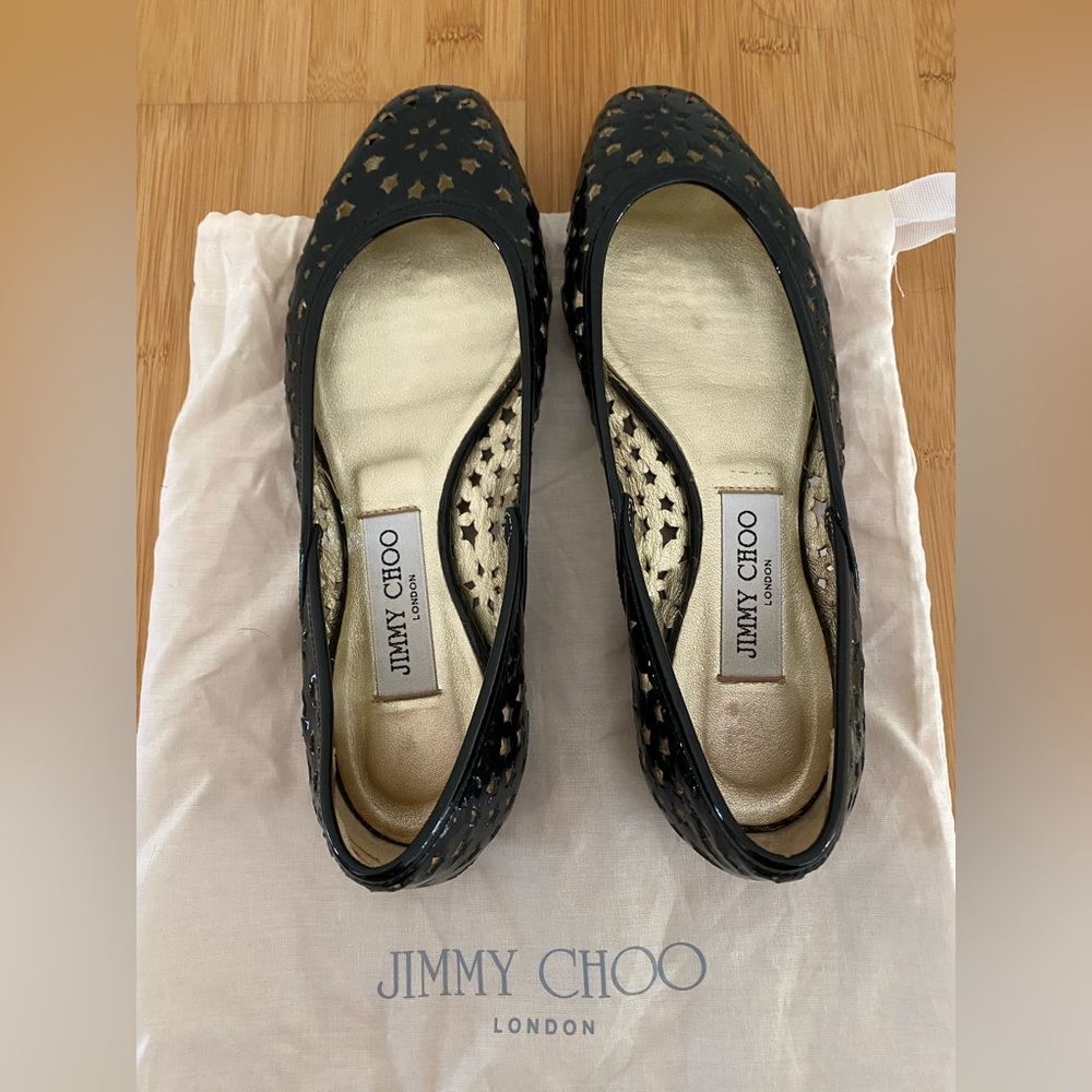 Jimmy Choo flats. Black laser-cut patent leather.